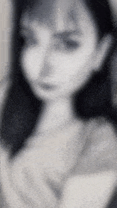 a blurry picture of a woman 's face with a white background
