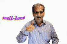 a man in a striped shirt giving a thumbs up with the word well-done behind him