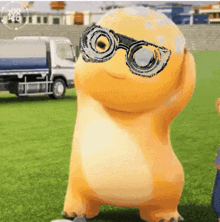 a cartoon character wearing sunglasses is standing on a grassy field