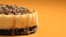 a cheesecake with caramel and nuts on it