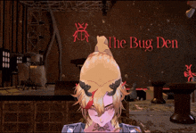 a girl with horns is in front of a sign that says the bug den