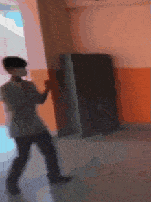 a blurred image of a man standing in a hallway