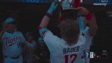 a baseball player wearing a helmet with bader 12 on the back of his jersey