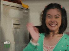 a girl in a green sweater with the words project exit on the bottom