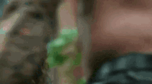 a close up of a woman 's face with a man 's face behind her .