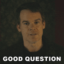 a man 's face is behind a good question sign
