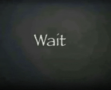 the word wait is written on a blackboard
