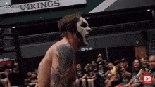 a man in a mask stands in front of a sign that says combatclashpdx