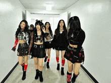 a group of girls walking down a hallway with the name njfaerie on the bottom right