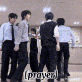 a group of men standing in a room with the word prayer on the bottom right