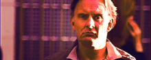 a man with a serious look on his face looks at the camera