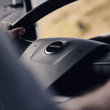 a close up of a volvo logo on a car steering wheel