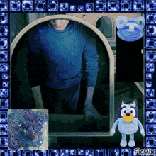 a picture of a man in a blue sweater with a pacifier next to it