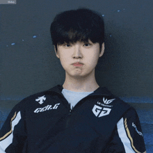 a young man wearing a jacket that says gen.g