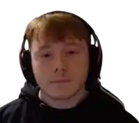 a man wearing headphones and a black hoodie looks at the camera .
