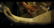 a person washing their hands in a bathroom sink with the number 6 on the bottom left