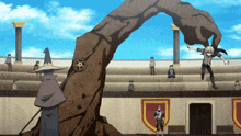 a man in a wizard hat is standing in front of a giant rock