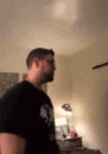 a blurry picture of a man wearing a black shirt that says ' a ' on it