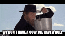 a man in a black hat is pouring milk into a bucket with the words we don t have a cow