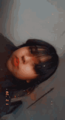 a close up of a woman 's face with the date 12/20