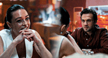 a man and a woman are sitting at a table and smiling at each other
