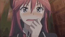 a girl with pink hair is making a funny face with her hand on her mouth .