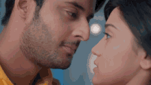 a man and a woman are looking at each other with their eyes closed