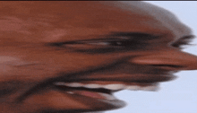 a close up of a man 's face with a smile on it