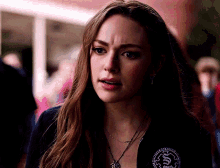 a close up of a woman wearing a jacket with a badge on it that says ' sd ' on it