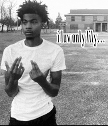 a black and white photo of a young man giving the middle finger with the caption " iluv only lily "