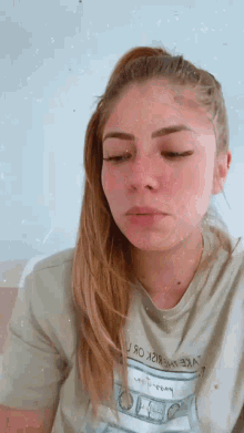 a woman wearing a t-shirt that says ' u.s. dollars ' on it