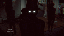 a man in a top hat stands in a dark room with the time of 04:07