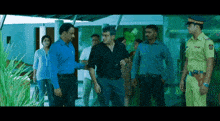 a man in a black shirt talks to a man in a blue shirt