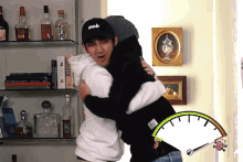 a man in a mob hat hugging another man