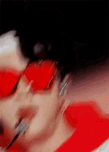 a blurry picture of a person 's face with red lipstick on it
