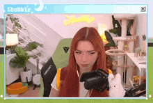 a girl with red hair is playing a video game