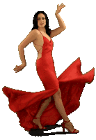 a woman in a red dress is dancing