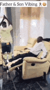 a man is sitting in a recliner in a living room while another man stands in the background