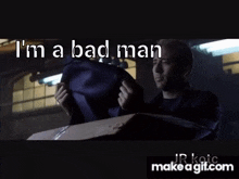 a man is holding a purple bag in a box and says `` i 'm a bad man '' .