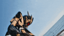 a person in a robot costume is standing on a beach