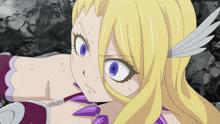 a girl with blonde hair and blue eyes is wearing a chain around her neck