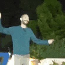 a blurry picture of a man in a blue shirt dancing