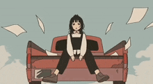 a girl is sitting in the back of a truck with papers flying around her