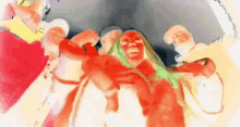 a group of people are standing next to each other in a room with their faces painted red and green .