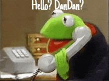 kermit the frog is talking on a telephone with the words `` hello ? dandan ? '' above him .