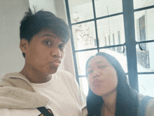 a man and a woman are making funny faces