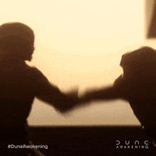 a poster for dune awakening shows a couple shaking hands