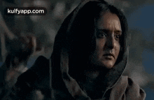 a woman is holding a lantern in her hand and crying .