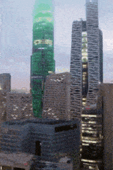a very tall building with a green light on the top of it