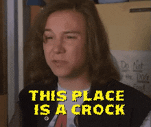 a man with long hair has the words this place is a crock above him
